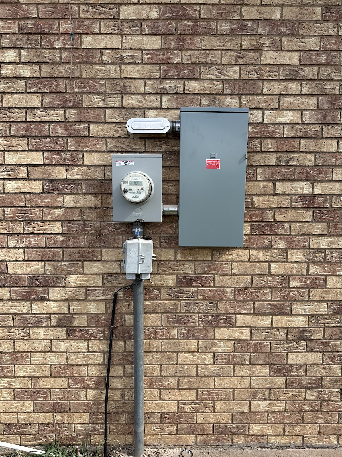 Electrical service entrance installed on a brick building