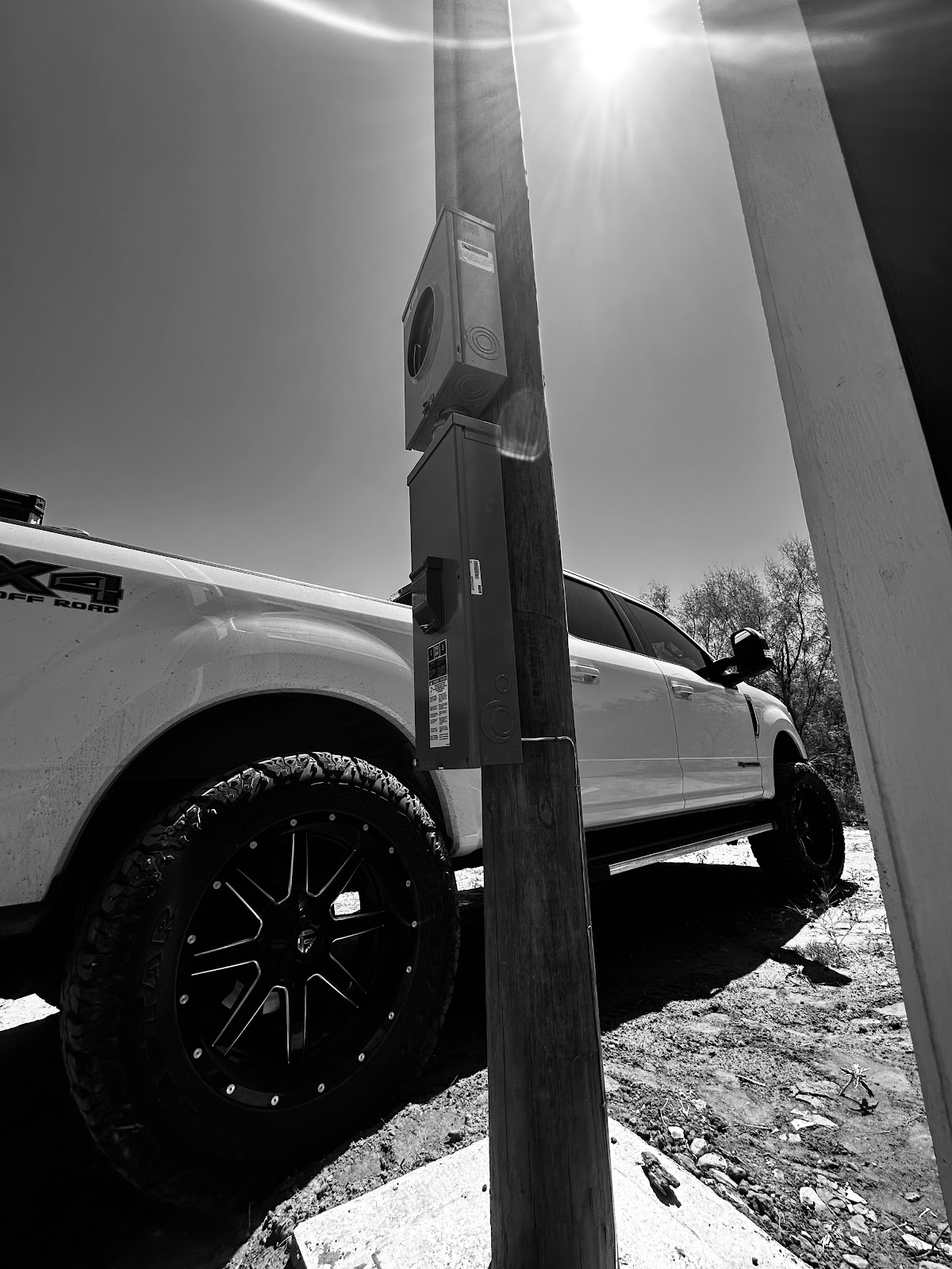 A Coy Electric service pole and work truck out on a West Texas job